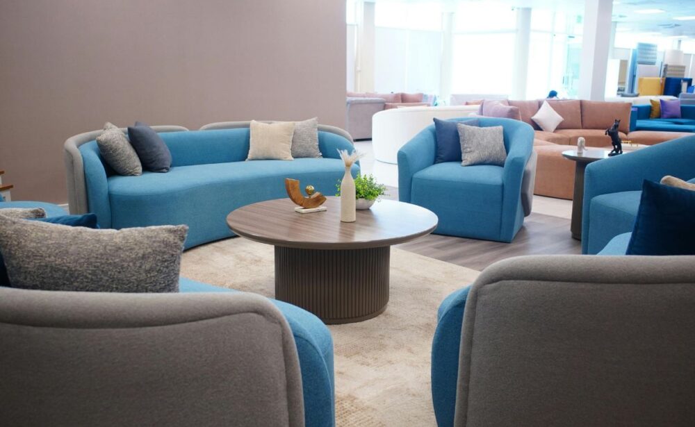 Modern blue and grey restaurant dining sofas in a spacious interior by Get Furniture, a leading Restaurant Dining Sofas Manufacturer Delhi